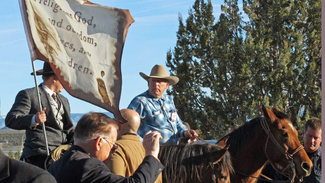 Cliven Bundy, on horseback at center, joins the funeral procession for Arizona rancher Robert "LaVoy" Finicum in Kanab, Utah, Friday, Feb. 5, 2016. Hundreds of people packed a Mormon church in rural Utah for the viewing ceremony for the fallen spokesman of the Oregon armed standoff. Police shot and killed Finicum during a Jan. 26 traffic stop after they say he reached for a gun. His supporters called it an ambush.(AP Photo/Felicia Fonseca)