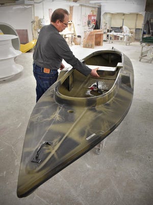 Jim Carstens demonstrates the moveable seat on a Carstens Bluebill model duck boat at Carstens Industries, Inc. in Melrose, Minn. Carstens Industries produces 500 duck boats on an average year. Over the past 35 years, Carstens estimated the business has donated 240 boats to conservation organizations such as the Minnesota Waterfowl Association, Ducks Unlimited, Delta Waterfowl Association and Pheasants Forever.