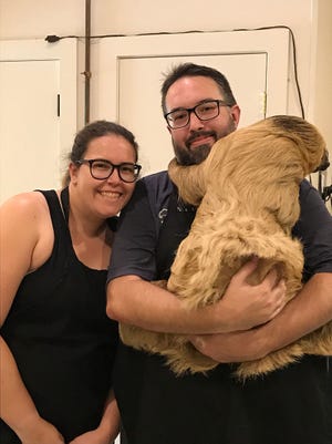 New Zealand couple is all smiles after traveling over 7,000 miles for a personal encounter with the Hattiesburg Zoo’s two-toed sloth Chewy.