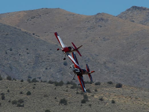 Racing planes make their way around a pylon during