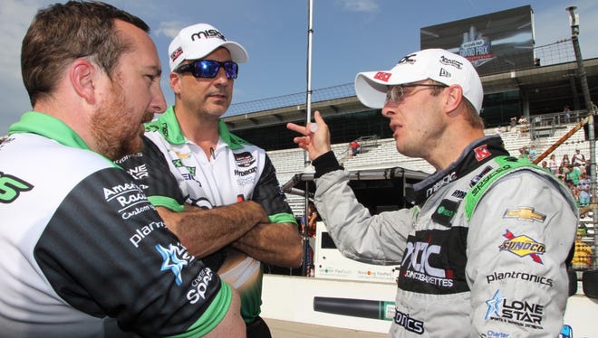 Driver Sebastien Bourdais debriefs after the Angie's List Grand Prix, with Engineer Olivier Boisson and crew member Bill Pappas, May 9, 2015.