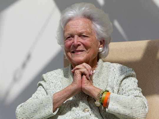 Former first lady Barbara Bush listens to a patient's
