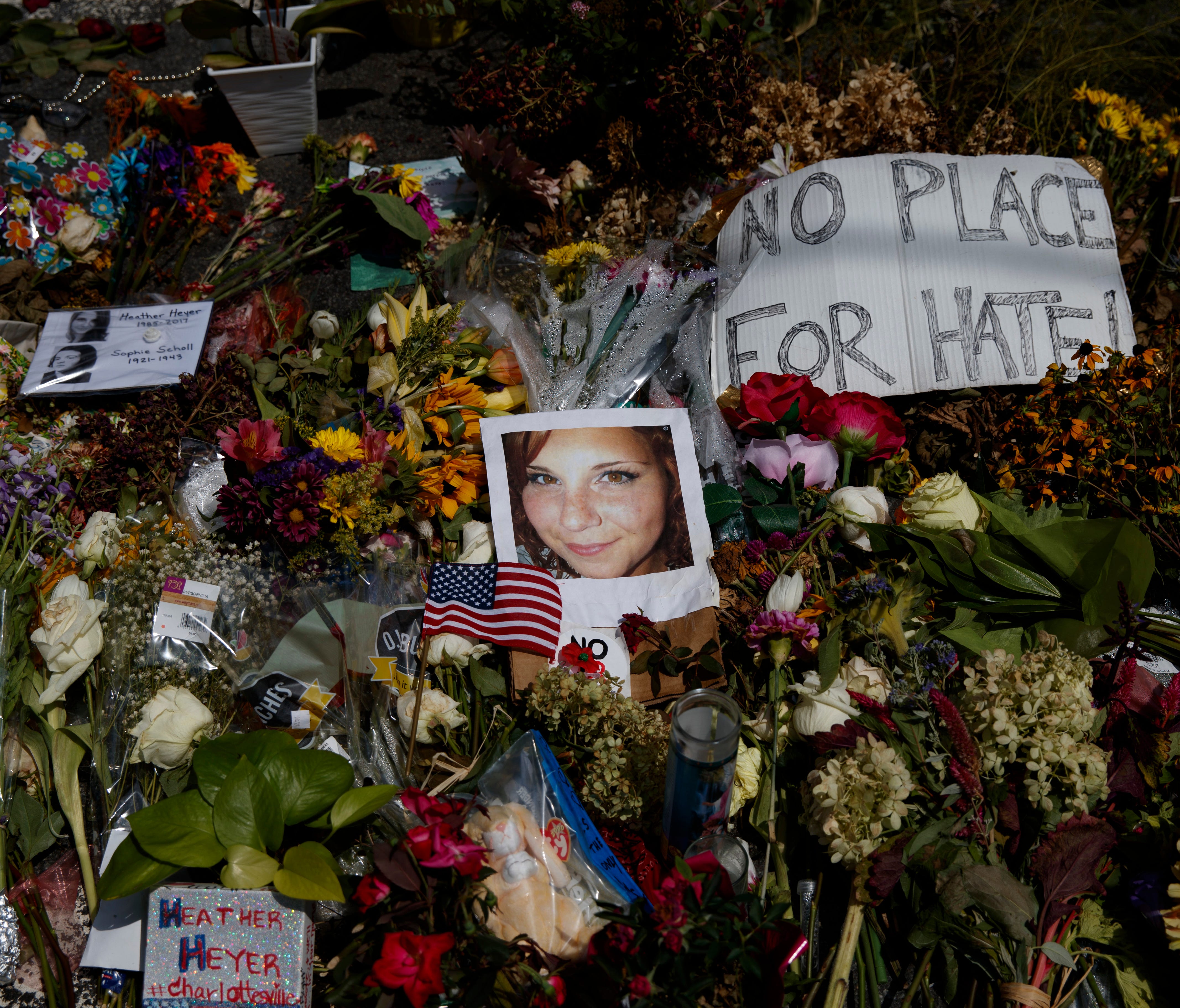 A photo of Heather Heyer, who was killed during a white nationalist rally, sits on the ground at a memorial the day her life was celebrated at the Paramount Theater on Aug. 16, 2017 in Charlottesville, Va.