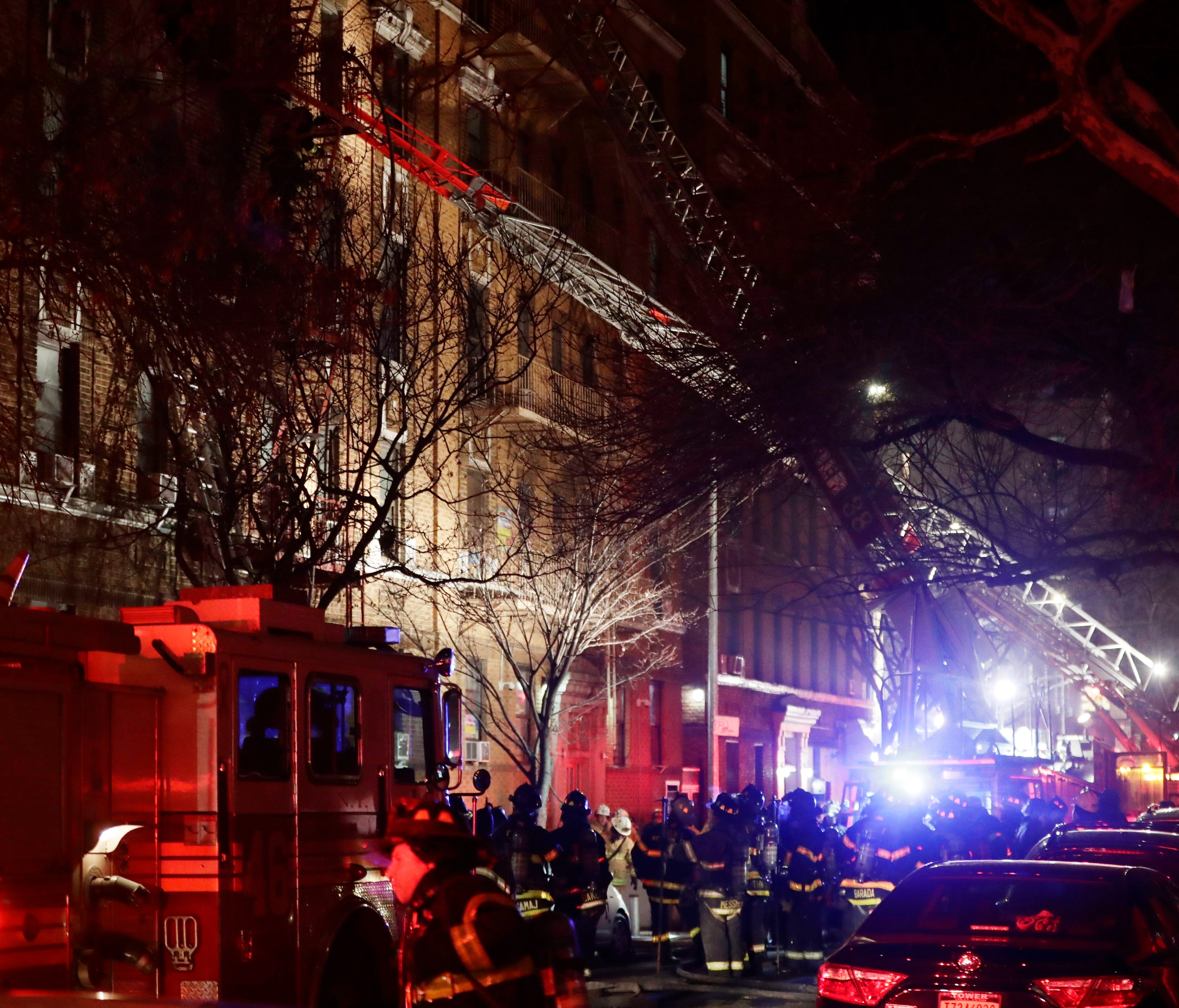 Firefighters respond to a building fire Thursday, Dec. 28, 2017, in the Bronx borough of New York. The Fire Department of New York says a blaze raging in the Bronx apartment building has killed at least six and seriously injured more than a dozen.