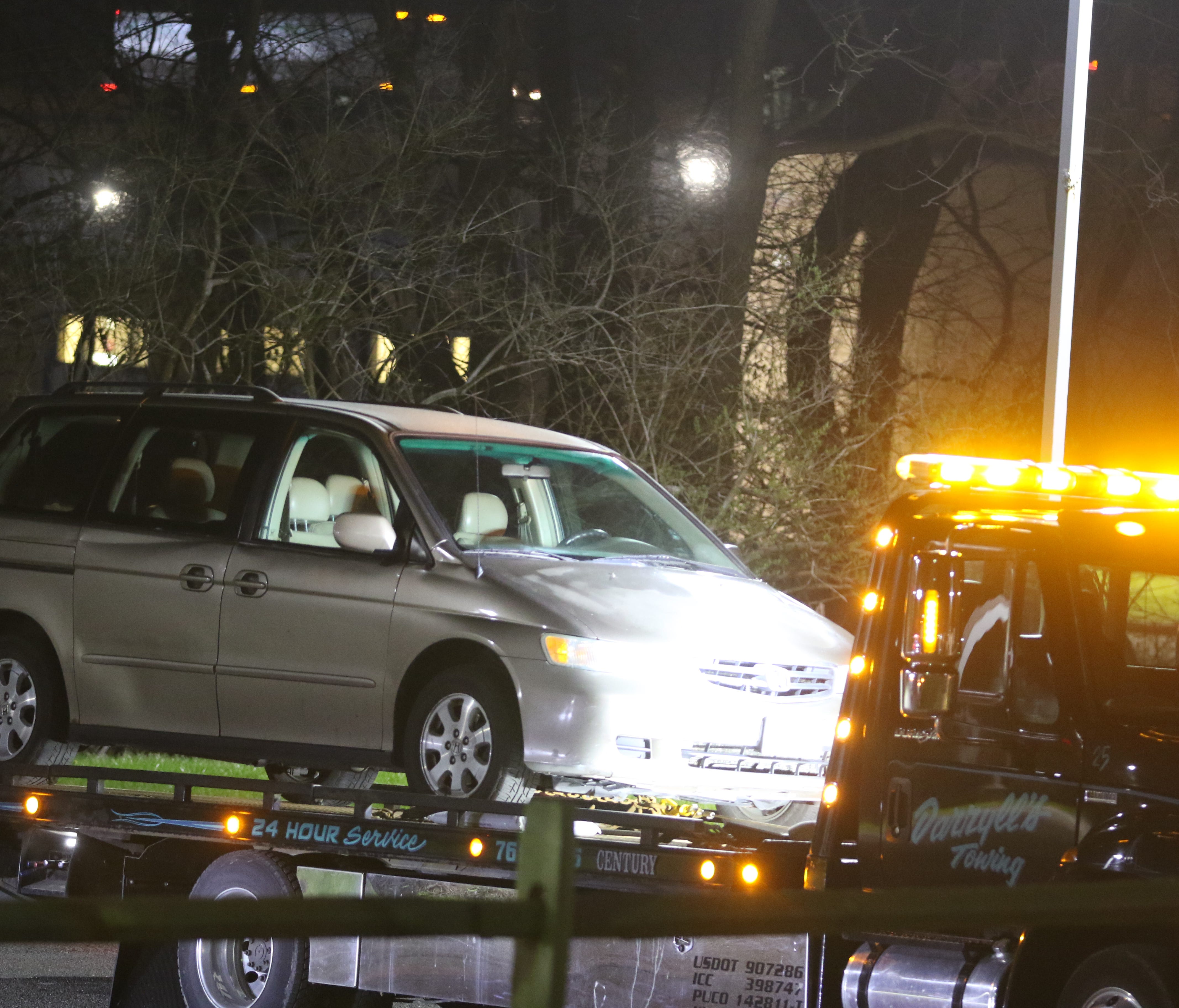 A minivan is towed away from the scene of a death a Seven Hills School.