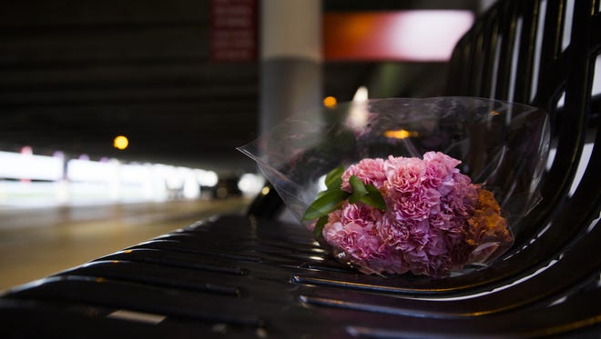 A bouquet of flowers rests on a bench outside  Terminal 2 baggage claim  Sunday at Fort Lauderdale-Hollywood International Airport.