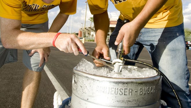 ASU tailgaters try to tap a keg outside of Sun Devil Stadium in Tempe before a game in 2007.