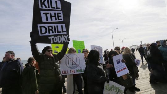 Groups protest an offshore drilling plan on the Asbury Park boardwalk in January.