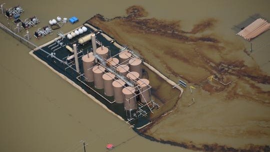 Oil hemorrhages from a production site during June 2015 flooding on the Trinity River.