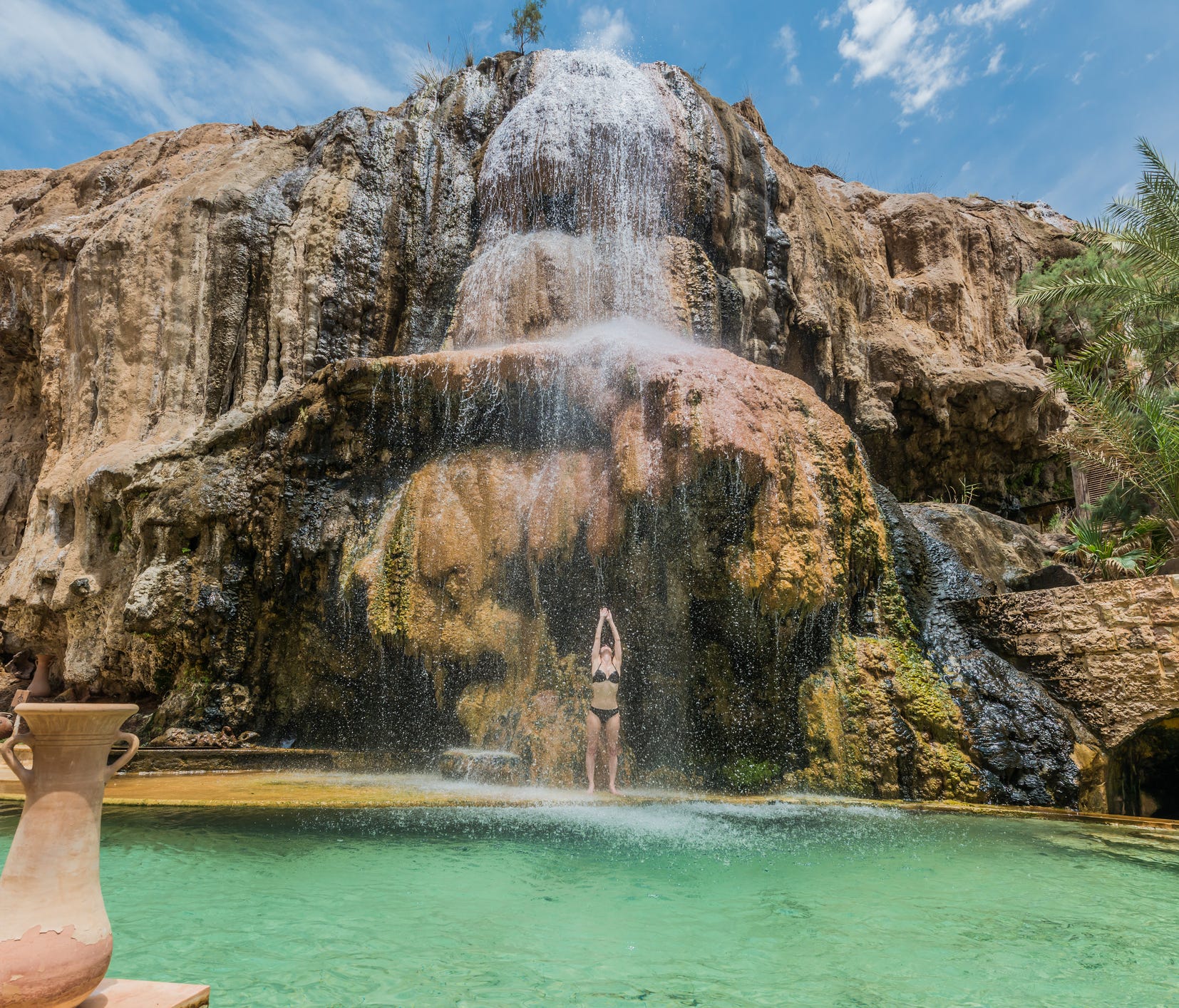 Discover your own desert oasis—complete with steaming waterfalls and hot spring pools—located near the Dead Sea at Ma'in Hot Springs in Jordan.