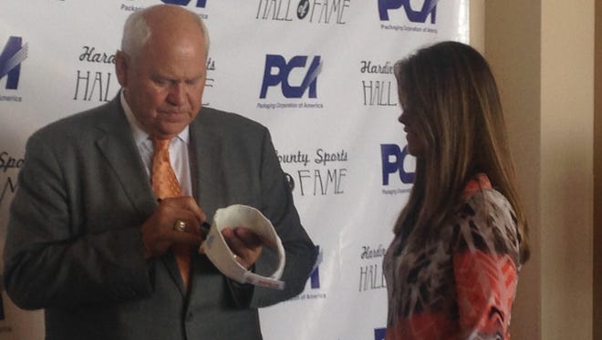 Phillip Fulmer signs a visor for a fan Monday at the Hardin County Sports Hall of Fame Banquet.