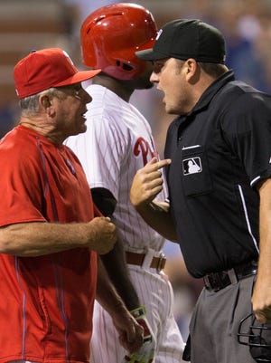 Home plate umpire Dan Bellino ejects Phillies bench coach Larry Bowa after he disputed a quick pitch by Mets relief pitcher Hansel Robles in the seventh inning Tuesday.