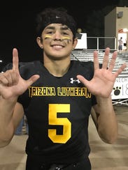 Arizona Lutheran junior Brandon Garcia holds up seven