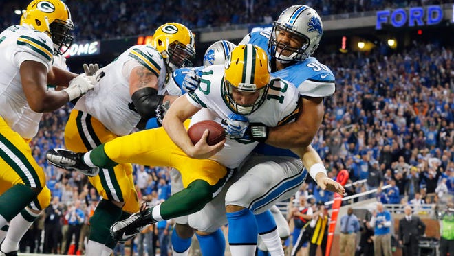 Detroit Lions defensive tackle Ndamukong Suh (90) sacks Green Bay Packers quarterback Matt Flynn for a safety during their 2013 game in Detroit.