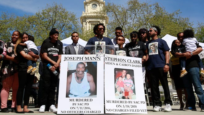 In this March 31, 2018, file photo, Curtis Gordon, center, the uncle of Stephon Clark, speaks at a rally aimed at ensuring Clark's memory and calling for police reform in Sacramento, Calif.