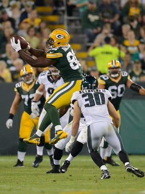 Green Bay Packers tight end Kennard Backman (86) makes a leaping catch in front of Philadelphia Eagles  safety Ed Reynolds (30) in the fourth third quarter during their preseason game at Lambeau Field.