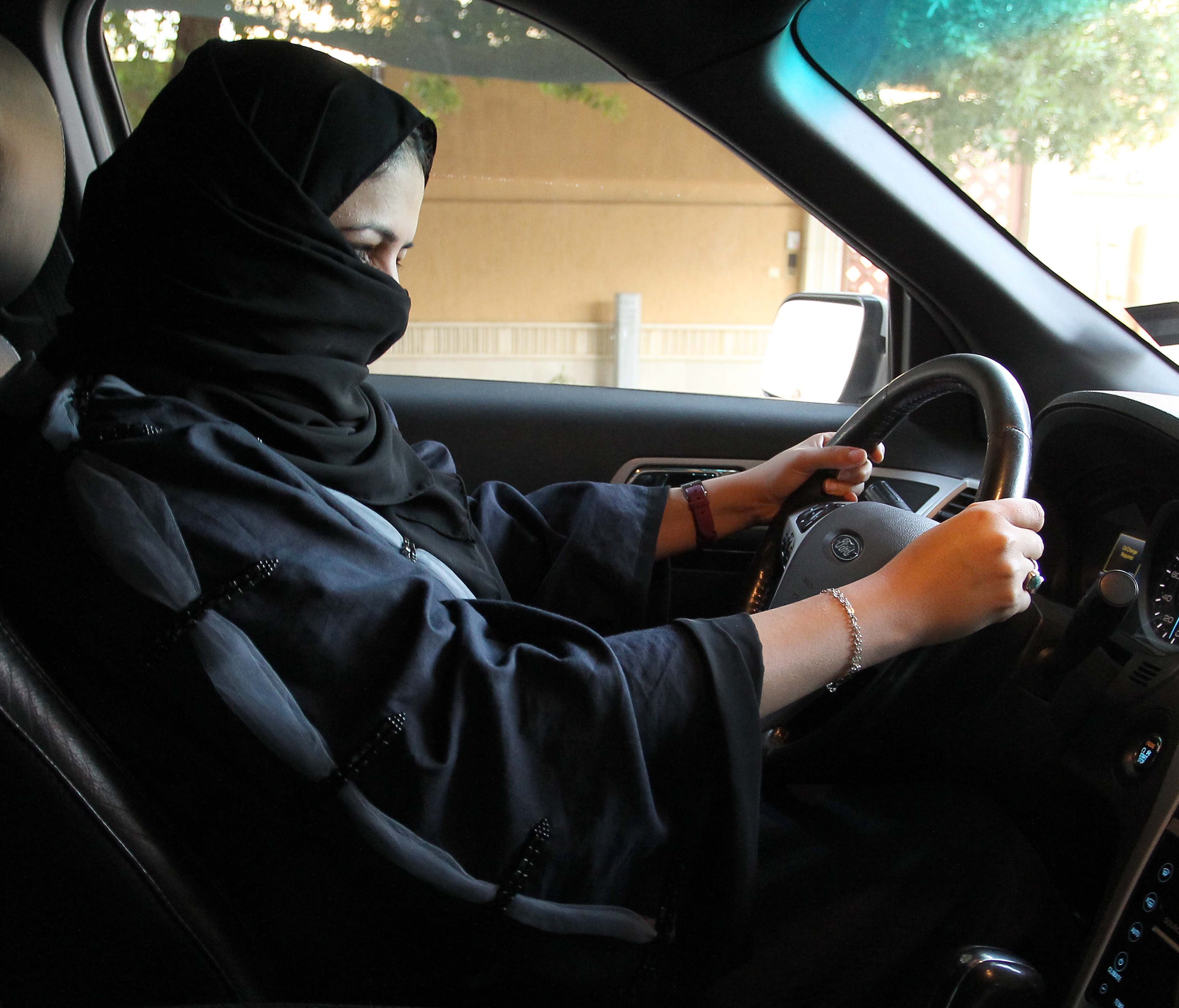 A woman sits behind the wheel of a car in Riyadh, Saudi Arabia, on Sept. 27, 2017.