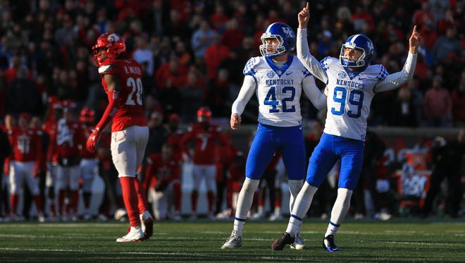 Kentucky kicker Austin MacGinnis celebrates with holder Tristan Yeomans after a 47-yard field goal from  with 12 seconds remaining for a 41-38 win.