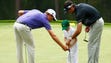 Webb Simpson and Bubba Watson with Simpson's son on