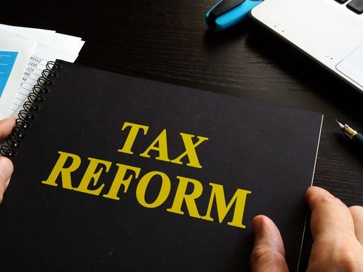 Black notebook with tax reform written in yellow letters on the cover.