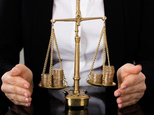 A scale roughly balanced with coins on both sides.