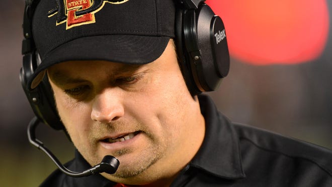 Dec 20, 2012; San Diego, CA, USA; San Diego State Aztecs safeties coach Danny Gonzales talks on the headset during the first quarter against the Brigham Young Cougars at Qualcomm Stadium.