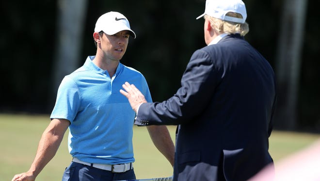 Donald Trump talks to Rory McIlroy during the final round of the World Golf Championships-Cadillac Championship at Trump National Doral Blue Monster Course  on March 6, 2016.