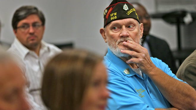 Department of Indiana VFW Buddy Poppy Chairman Jerry Morgan and other supporters listen at the opening of the Indianapolis Veterans Court on Friday, October 2, 2015, at the City-County Building.
