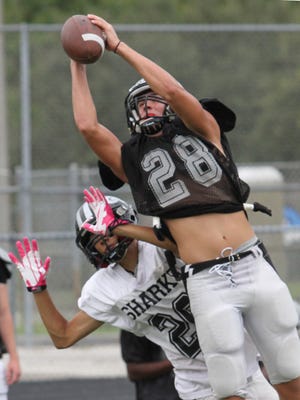 Gulf Coast High’s Will Sheriffs makes a catch against the defense of Alfonso Martinez during practice Tuesday.
