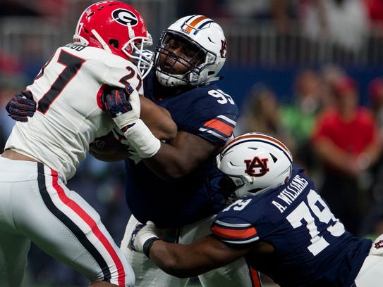 Auburn defensive lineman Dontavius Russell (95) tackles