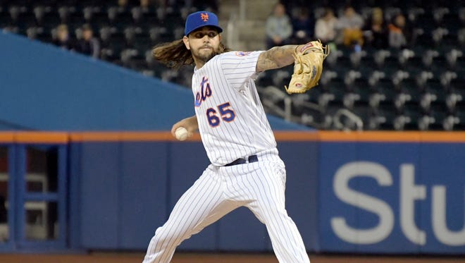 New York Mets pitcher Robert Gsellman winds up during the first inning of a baseball game against the Philadelphia Phillies, Wednesday, Sept. 6, 2017, in New York.