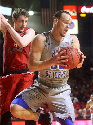 MTSU's Reggie Upshaw Jr. (30) turns to go up for a shot as Western Kentucky's Ben Lawson (14) guards him on Thursday, Feb. 16, 2017.