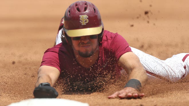 FSU’s Drew Mendoza slides safely in to third base in the first game of their doubleheader against Mount St. Mary’s at Dick Howser Stadium on Saturday, May 12, 2018.