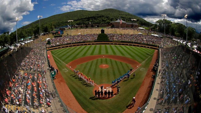 FILE - In this Sunday, Aug. 25, 2019, file photo, River Ridge, Louisiana, lines the third baseline and Curacao lines the first baseline during team introductions before the Little League World Series Championship game at Lamade Stadium in South Williamsport, Pa. The 2020 Little League World Series and the championship tournaments in six other Little League divisions have been canceled because of the new coronavirus pandemic. (AP Photo/Gene J. Puskar, File)
