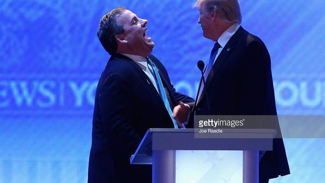 New Jersey Gov. Chris Christie (left) s spending Super Tuesday on the road in Kentucky and Ohio to stump for Republican frontrunner Donald Trump, who Christie endorsed last week -- enraging both anti-Trump Republicans and Democrats carping that Christie is never home doing his job as governor. Here the two men share a laugh during a commercial break in the Republican presidential debate at St. Anselm College February 6, 2016 in Manchester, New Hampshire. (Getty Images)