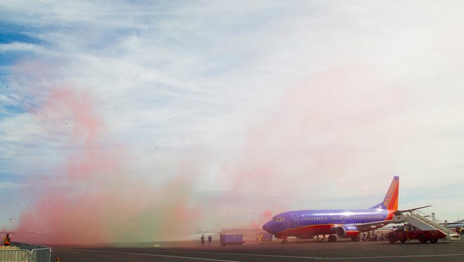 A Southwest plane sits as fake smoke rises during an Emergency Preparedness Exercise at Phoenix Sky Harbor International Airport on Thursday, Oct. 30, 2014.