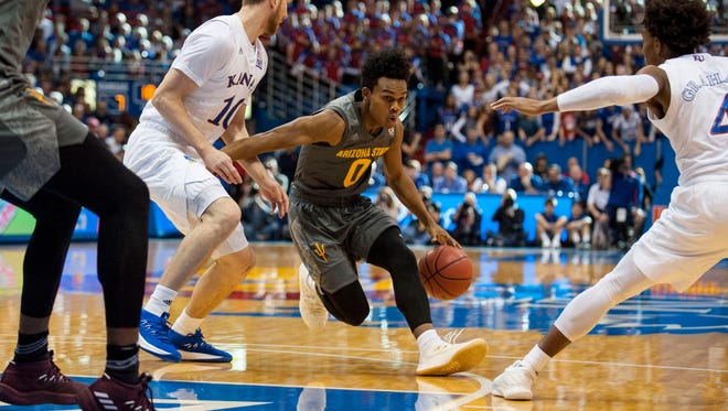 Arizona State guard Tra Holder dribbles the ball past Kansas during the first half.