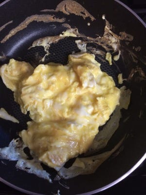 Remove scrambled eggs from heat when they're still wet.