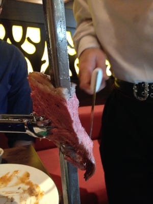 Gauchos, or Brazilian cowboys, serve cuts of meat at your table at Rodizio Grill.