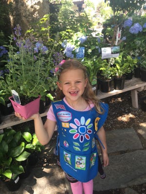Eleanor Joiner, a Girl Scout Daisy, shows off a drought-tolerant plant she got at Moana Nursery during an RGJ Water Savers Club event.