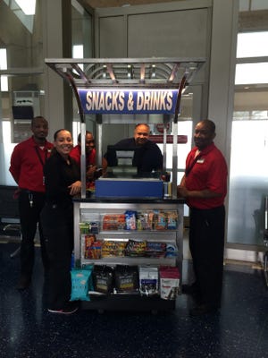 A Paradies Lagardère Travel Retail "At Your Service" cart at Kansas City International Airport.