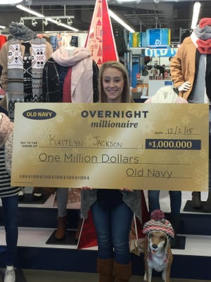 Kaitlyn Jackson, of Piedmont, accepts a $1 million check from Old Navy. She won the store's Overnight Millionaire contest for shopping on Thanksgiving night.