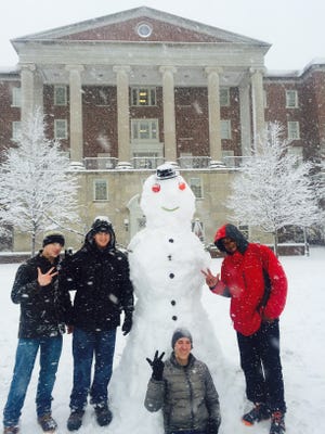 Vanderbilt first year students with their snowman Friday morning on the Ingram Commons and Stambaugh House at Vanderbilt.