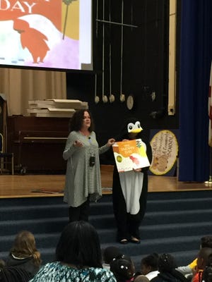 Melinda Leonard and Elizabeth Walker read a story about winter friends and snow days to pre-K students and families at C.A. Weis for Family Night.