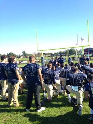 Freehold head coach Dave Ellis addresses his team after the win over Colts Neck