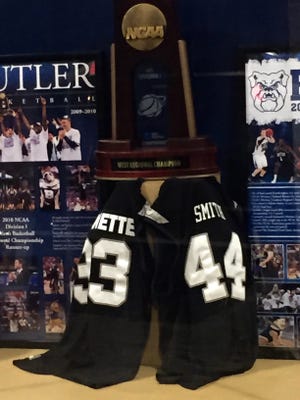 Jerseys of the late Joel Cornette (33) and Andrew Smith (44) are in a display case at Hinkle Fieldhouse.