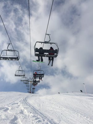 Skiers and snowboarders ride one of the new lifts at Wilmot Mountain in Kenosha County.