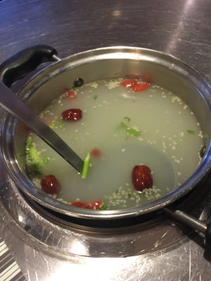 The chicken broths at Yummy Garden Hot Pot are made with bone-in chicken breast, sesame seed, goji berry, red date and scallion.