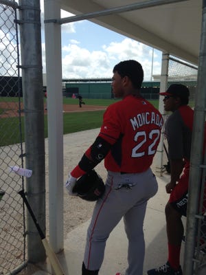 Yoan Moncada, who received a $31.5 million signing bonus from the Boston Red Sox, prepares for his first professional at-bat with the Boston Red Sox. He tripled in an extended spring training game at Fenway South on Monday, April 13, 2015.