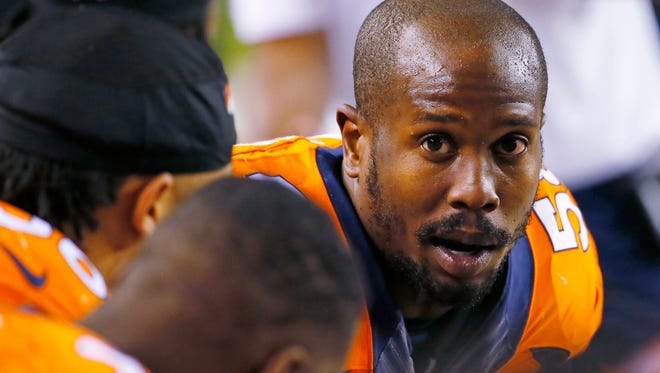 In this Nov. 15, 2015, file photo, Denver Broncos outside linebacker Von Miller talks with teammates during an NFL football game against the Kansas City Chiefs in Denver. A person with knowledge of the negotiations tells The Associated Press that the Broncos have upped their offer to Miller by offering to guarantee a record $70 million of the six-year deal. The person spoke to the AP on condition of anonymity to share candid details of the blockbuster offer.